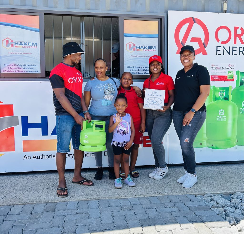 African american people smiling and posing with gas cylinder